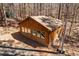 View of building featuring a brick foundation, row of windows, set among tall trees and offering a private setting at 735 Jordan Hills Loop, Chapel Hill, NC 27517