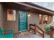 Charming front porch features a green door and wooden details, enhancing the home's exterior at 735 Jordan Hills Loop, Chapel Hill, NC 27517