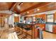 Kitchen with wood ceiling, hardwood floors, granite countertops, stainless steel appliances, and breakfast bar at 735 Jordan Hills Loop, Chapel Hill, NC 27517