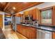 Spacious kitchen with hardwood floors, wood ceiling, granite countertops, stainless steel appliances and large windows at 735 Jordan Hills Loop, Chapel Hill, NC 27517