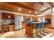 Kitchen with wood ceiling, hardwood floors, granite countertops, stainless steel appliances, and breakfast bar at 735 Jordan Hills Loop, Chapel Hill, NC 27517