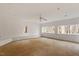 Spacious living room with multiple windows showcasing wooded views at 735 Jordan Hills Loop, Chapel Hill, NC 27517