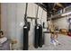 View of the basement utility area, showcasing water filtration system, water heater, and exposed ceiling with piping at 7504 Everton Way, Wake Forest, NC 27587