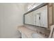 Bright bathroom featuring a decorative mirror, vanity, and countertop sink at 7504 Everton Way, Wake Forest, NC 27587