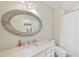 Bathroom featuring a marble countertop with a large decorative mirror above the sink at 7504 Everton Way, Wake Forest, NC 27587