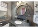 Charming bathroom with granite countertop, modern fixtures, decorative mirror, and gray walls at 7504 Everton Way, Wake Forest, NC 27587