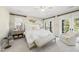 Bright bedroom with a king bed, bench seat and balcony access through glass doors at 7504 Everton Way, Wake Forest, NC 27587
