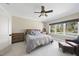 Cozy bedroom featuring a gray bed with decorative pillows, carpeted floors, and a window view at 7504 Everton Way, Wake Forest, NC 27587