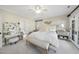 Bright bedroom with carpeted floors, a ceiling fan and a large white bed at 7504 Everton Way, Wake Forest, NC 27587