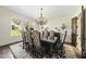 Formal dining room featuring a long table with ornate chairs, chandelier, and hardwood floors at 7504 Everton Way, Wake Forest, NC 27587