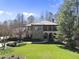 Stunning two-story home features a tile roof and stone accents, nestled on a sprawling green lawn at 7504 Everton Way, Wake Forest, NC 27587