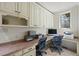 Functional home office featuring custom cabinetry, a large window with natural light, and dual workstations at 7504 Everton Way, Wake Forest, NC 27587