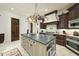 Gourmet kitchen features a large island, custom cabinetry, granite countertops, and stainless steel appliances at 7504 Everton Way, Wake Forest, NC 27587
