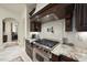 Close up view of the gourmet kitchen featuring a stainless gas range and custom hood at 7504 Everton Way, Wake Forest, NC 27587