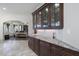 Kitchen area featuring granite countertops, dark wood cabinets, and white backsplash at 7504 Everton Way, Wake Forest, NC 27587