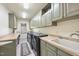 Spacious laundry room with a sink, countertop, and ample cabinet storage at 7504 Everton Way, Wake Forest, NC 27587