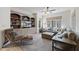 Living room featuring built-in bookshelves, large windows, and comfortable seating at 7504 Everton Way, Wake Forest, NC 27587