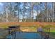 Backyard showing a patio with a Blackstone grill, bench, and view of the yard at 80 Westbrook Ln, Franklinton, NC 27525