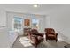 Bright bedroom with two cozy armchairs, perfect for relaxing, and bathed in natural light at 80 Westbrook Ln, Franklinton, NC 27525