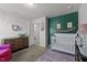Charming Bedroom with crib, changing table, and green accent wall with decor at 80 Westbrook Ln, Franklinton, NC 27525