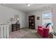Cozy bedroom featuring a chair and shelving unit, complemented by natural light from the window at 80 Westbrook Ln, Franklinton, NC 27525