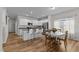 Bright, open kitchen featuring white cabinetry, stainless steel appliances, a breakfast bar, and a dining area at 80 Westbrook Ln, Franklinton, NC 27525