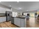 Open concept kitchen features stainless steel appliances, large island, and seamless flow into living area at 80 Westbrook Ln, Franklinton, NC 27525