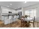 Eat-in kitchen with center island, stainless appliances, white cabinets, granite countertops, and a breakfast table at 80 Westbrook Ln, Franklinton, NC 27525