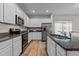 Well-lit kitchen featuring stainless steel appliances, granite countertops, and ample storage space at 80 Westbrook Ln, Franklinton, NC 27525