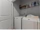 Well-equipped laundry room with modern washer and dryer, shelving, and ample space for laundry tasks at 80 Westbrook Ln, Franklinton, NC 27525