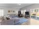 Bright living room with large sectional sofa, decorative rug, TV, and sliding glass door to patio at 80 Westbrook Ln, Franklinton, NC 27525