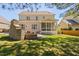 Spacious backyard featuring a covered porch and stone fireplace, perfect for outdoor living at 804 Cambridge Hall Loop, Apex, NC 27539