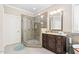 This bathroom features a glass shower and a dark wood vanity with a light countertop at 804 Cambridge Hall Loop, Apex, NC 27539