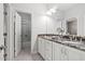 Elegant bathroom featuring a double vanity with granite countertops and a separate shower/tub room at 804 Cambridge Hall Loop, Apex, NC 27539