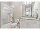 Well-lit bathroom with a shower, vanity, and granite countertop, creating a clean and functional space at 804 Cambridge Hall Loop, Apex, NC 27539