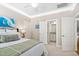 Well-lit bedroom with coordinating decor and a doorway to the en suite bathroom at 804 Cambridge Hall Loop, Apex, NC 27539