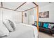 Stylish bedroom with a canopy bed, black leather couch, and bright accent pillows at 804 Cambridge Hall Loop, Apex, NC 27539