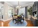 Charming dining room featuring a round table, hardwood floors, and decorative chandelier, creating an inviting atmosphere at 804 Cambridge Hall Loop, Apex, NC 27539