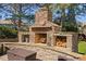 Outdoor stone fireplace with wood storage, a great addition to your backyard at 804 Cambridge Hall Loop, Apex, NC 27539