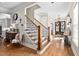Inviting foyer with hardwood floors, staircase, and view of the formal dining room at 804 Cambridge Hall Loop, Apex, NC 27539
