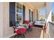 Relaxing front porch seating area with stylish chairs, table and love seat at 804 Cambridge Hall Loop, Apex, NC 27539