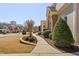 Manicured front yard with sidewalk leading to the covered front porch and stone accents at 804 Cambridge Hall Loop, Apex, NC 27539
