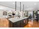 Open kitchen with a large island, pendant lights and views into the living room at 804 Cambridge Hall Loop, Apex, NC 27539