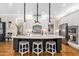 Stunning kitchen island featuring barstool seating and pendant lighting at 804 Cambridge Hall Loop, Apex, NC 27539