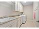 Well-equipped laundry room boasts ample cabinet storage and modern washer and dryer units at 804 Cambridge Hall Loop, Apex, NC 27539