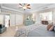 Bright, stylish main bedroom featuring neutral tones, ceiling fan and ensuite bathroom at 804 Cambridge Hall Loop, Apex, NC 27539