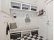 Well-organized mudroom featuring a built-in bench, cubbies, hooks, and black and white checkered floors at 804 Cambridge Hall Loop, Apex, NC 27539