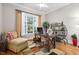Bright and airy office with large window, comfortable seating, and a stylish wooden desk at 804 Cambridge Hall Loop, Apex, NC 27539