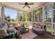 Inviting sunroom with comfortable seating, screened windows, and serene backyard views for relaxation at 804 Cambridge Hall Loop, Apex, NC 27539