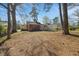 Large backyard with mature trees and a view of the back of the home at 818 Eastern Ave, Rocky Mount, NC 27801